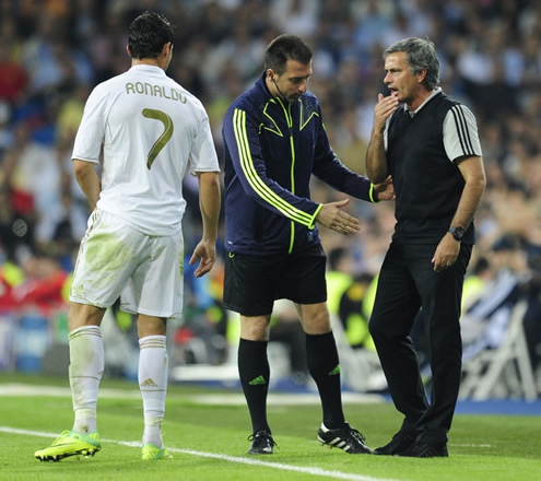 José Mourinho telling a secret to Cristiano Ronaldo, during a Real Madrid game in 2011-2012