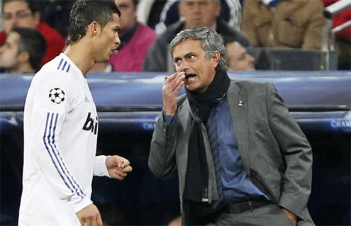 José Mourinho covering his mouth with his hand, while telling Cristiano Ronaldo his instructions