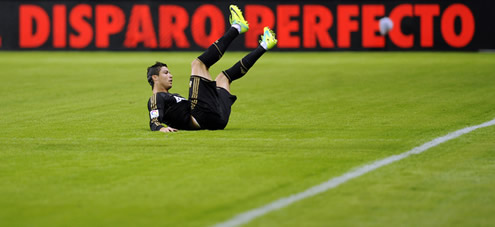 Cristiano Ronaldo goes to the ground and stays with his legs stretched up