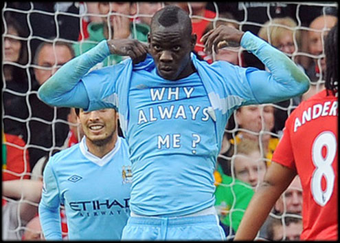 Mario Balotelli showing a shirt saying: 'Why Always me?', after scoring a goal in Manchester United 1-6 Manchester City, in the English Premier League 2011-2012