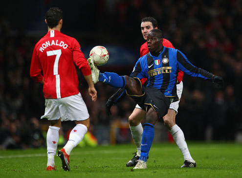 Cristiano Ronaldo looking at Mario Balotelli as the Italian controls the ball in a Manchester United vs Inter Milan match, for the UEFA Champions League
