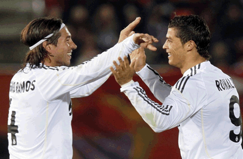Sergio Ramos and Cristiano Ronaldo preparing to hug each other