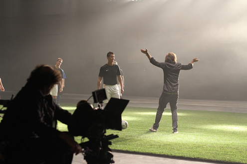 Cristiano Ronaldo smiles while a crazy man waves at him