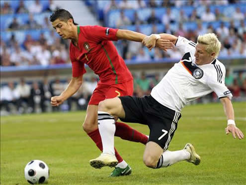 Cristiano Ronaldo and Bastian Schweinsteiger fighting for the ball