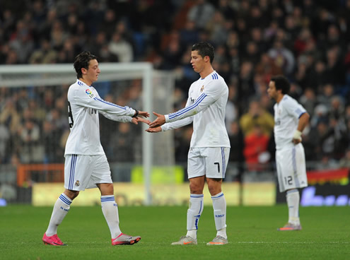 Cristiano Ronaldo giving hands to Mesut Ozil, before the German player gets substituted in a Real Madrid game