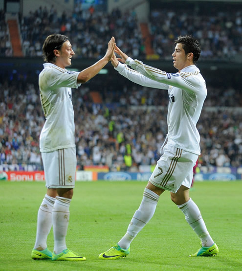 Mesut Ozil touching hands with Cristiano Ronaldo in the Santiago Bernabéu