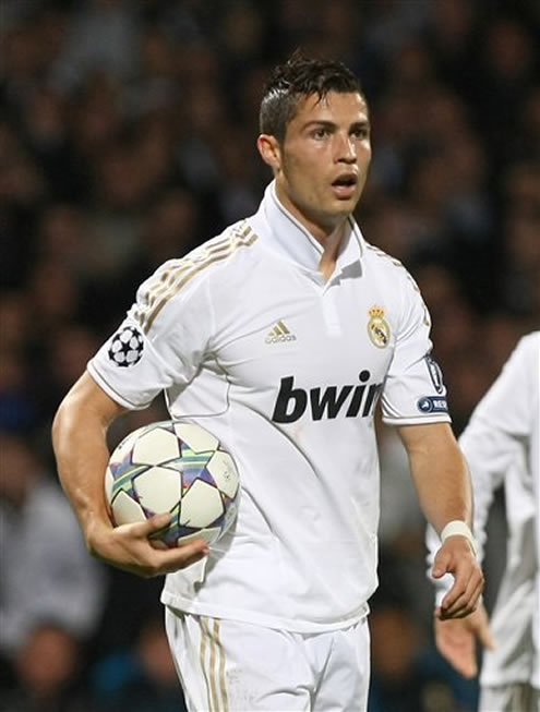 Cristiano Ronaldo grabs the ball and holds it under his arm