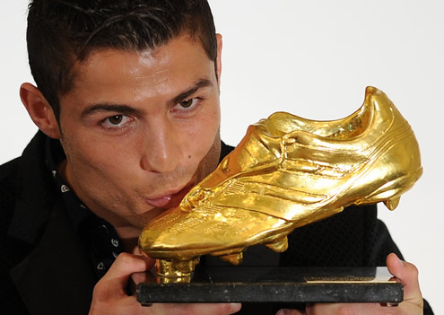 Cristiano Ronaldo taking a photo holding and kissing the Golden Shoe 2011
