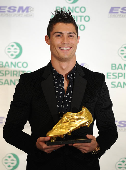 Cristiano Ronaldo in a suit and showing his happiness for having won the European Golden Shoe