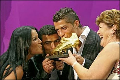 Cristiano Ronaldo and his family holding and kissing the European Golden Shoe award 2011