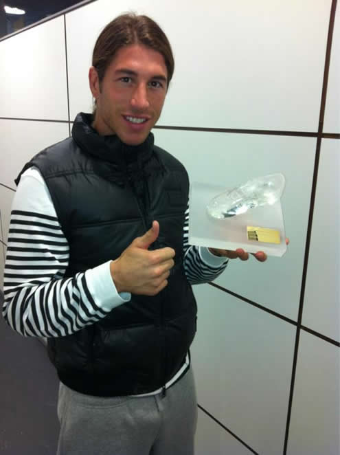 Sergio Ramos showing a crystal shoe (boot), that Cristiano Ronaldo offered as a gift to all his Real Madrid teammates, after having won the Golden Shoe award 2011