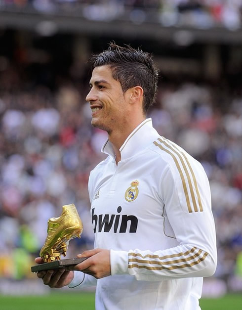 Cristiano Ronaldo taking a photo holding the European Golden Shoe award 2011, in the Santiago Bernabéu