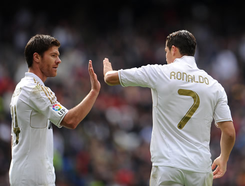 Cristiano Ronaldo touching hands with Xabi Alonso